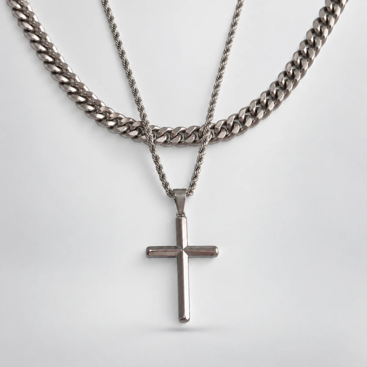 silver minimalist cross necklace layered set white background
