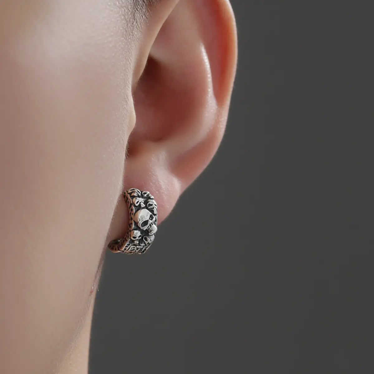 6mm Silver Skull Cluster Huggie Hoop Earrings Worn by Male Model Close Up
