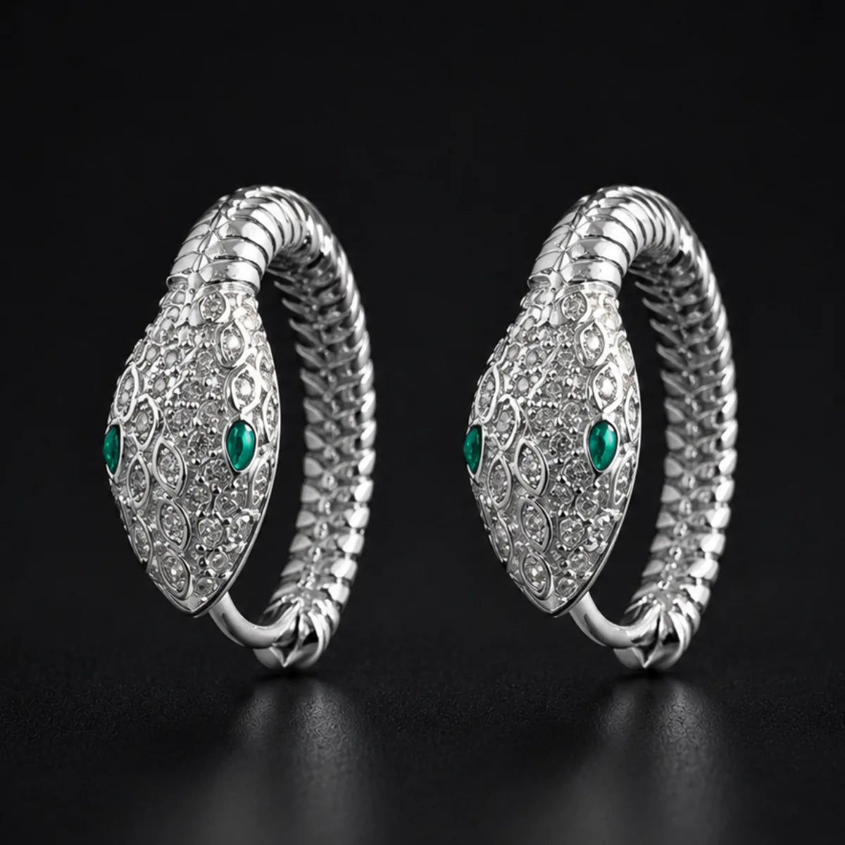 925 Silver Emerald Eye Snake Hoop Earrings Pair Close Up Black Background