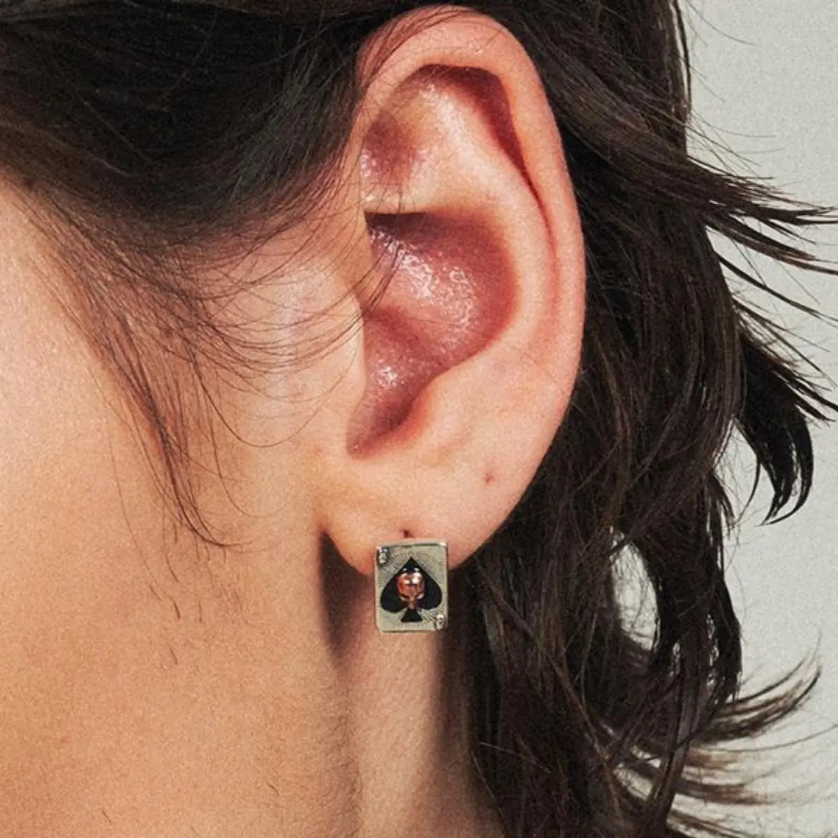 Ace of Spades Skull Earrings Worn by Male Model Close Up