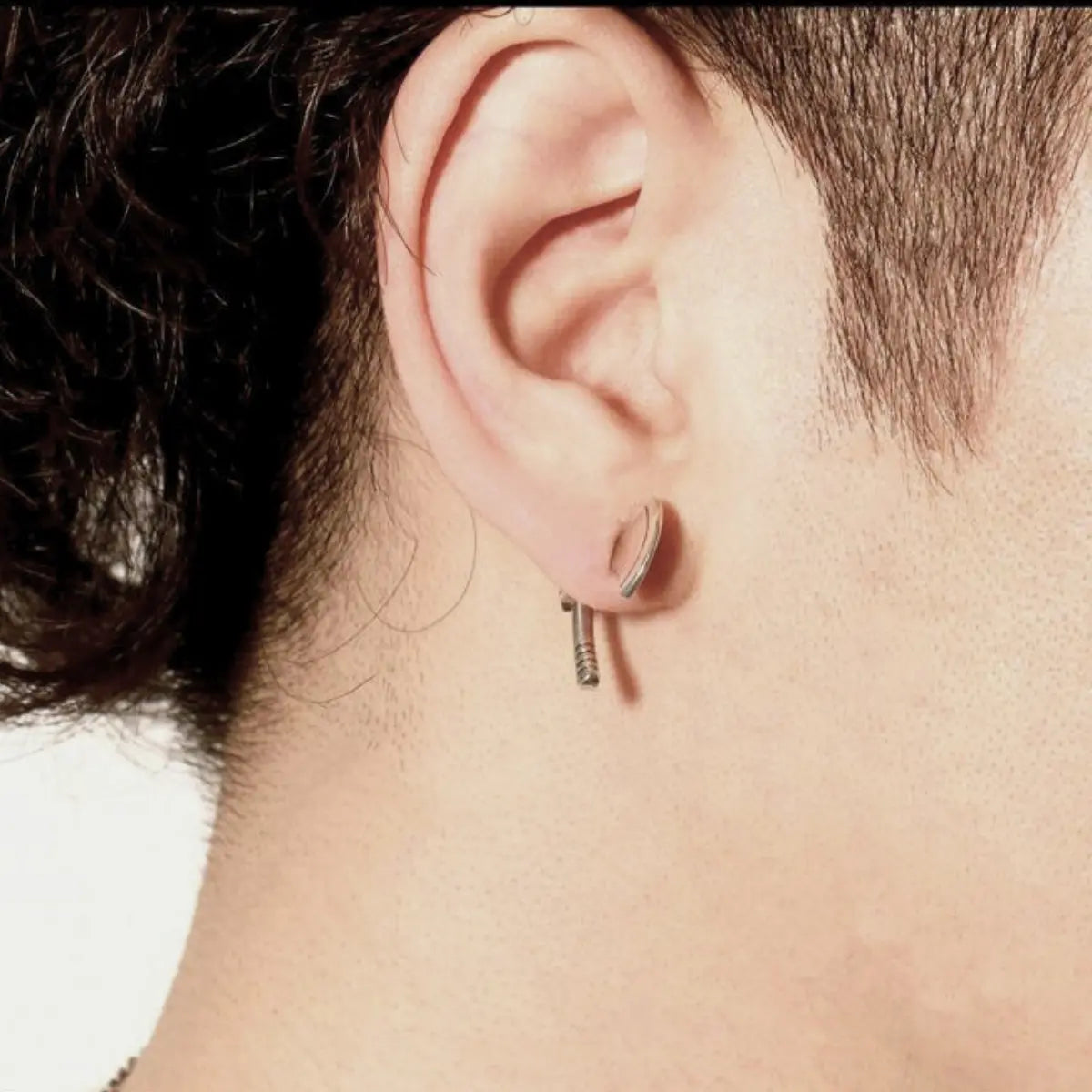 Axe Stud Earrings Sterling Silver Worn By Male Model Side View