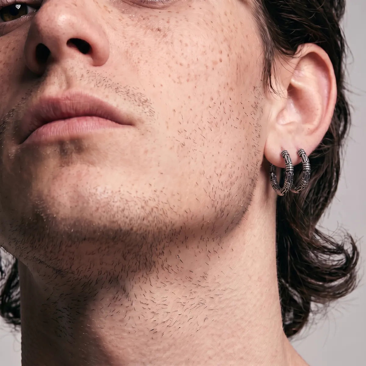 Bali Hoop Earrings Silver Worn by Male Model Side View