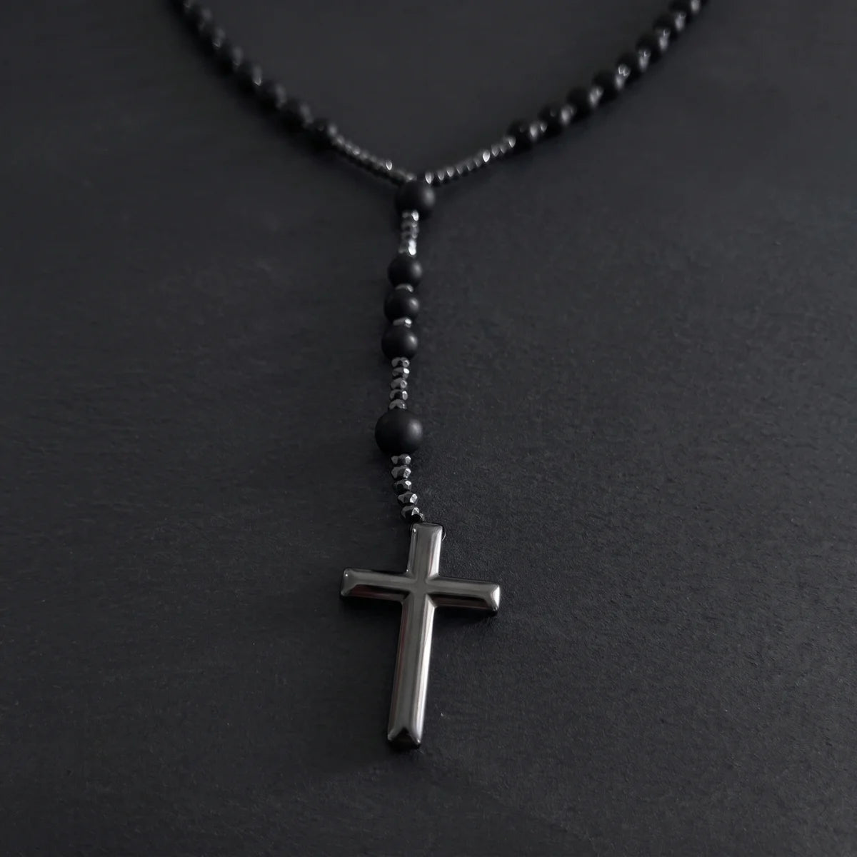 Black Beaded Cross Necklace Close Up Black Background