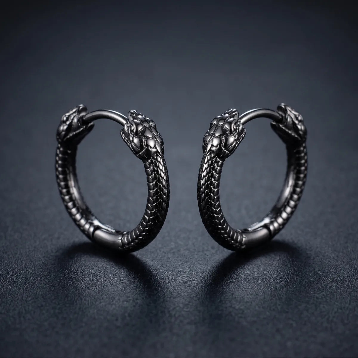 Black Double Snake Head Hoop Earrings Close Up Black Background