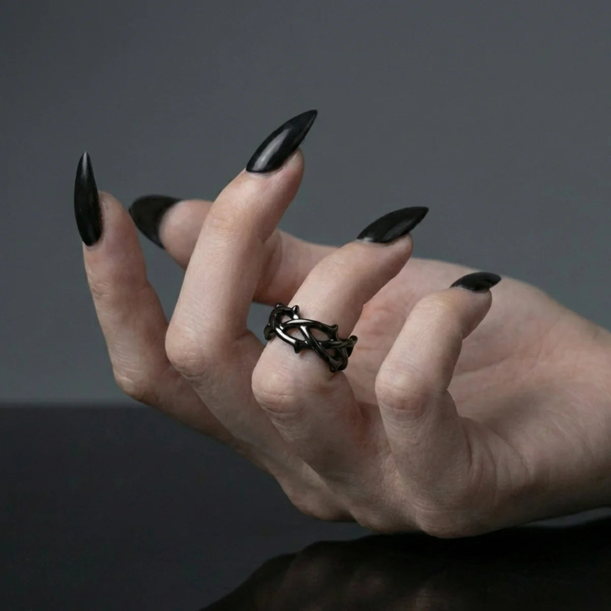 Black Minimalist Thorns Ring Worn by Female Model
