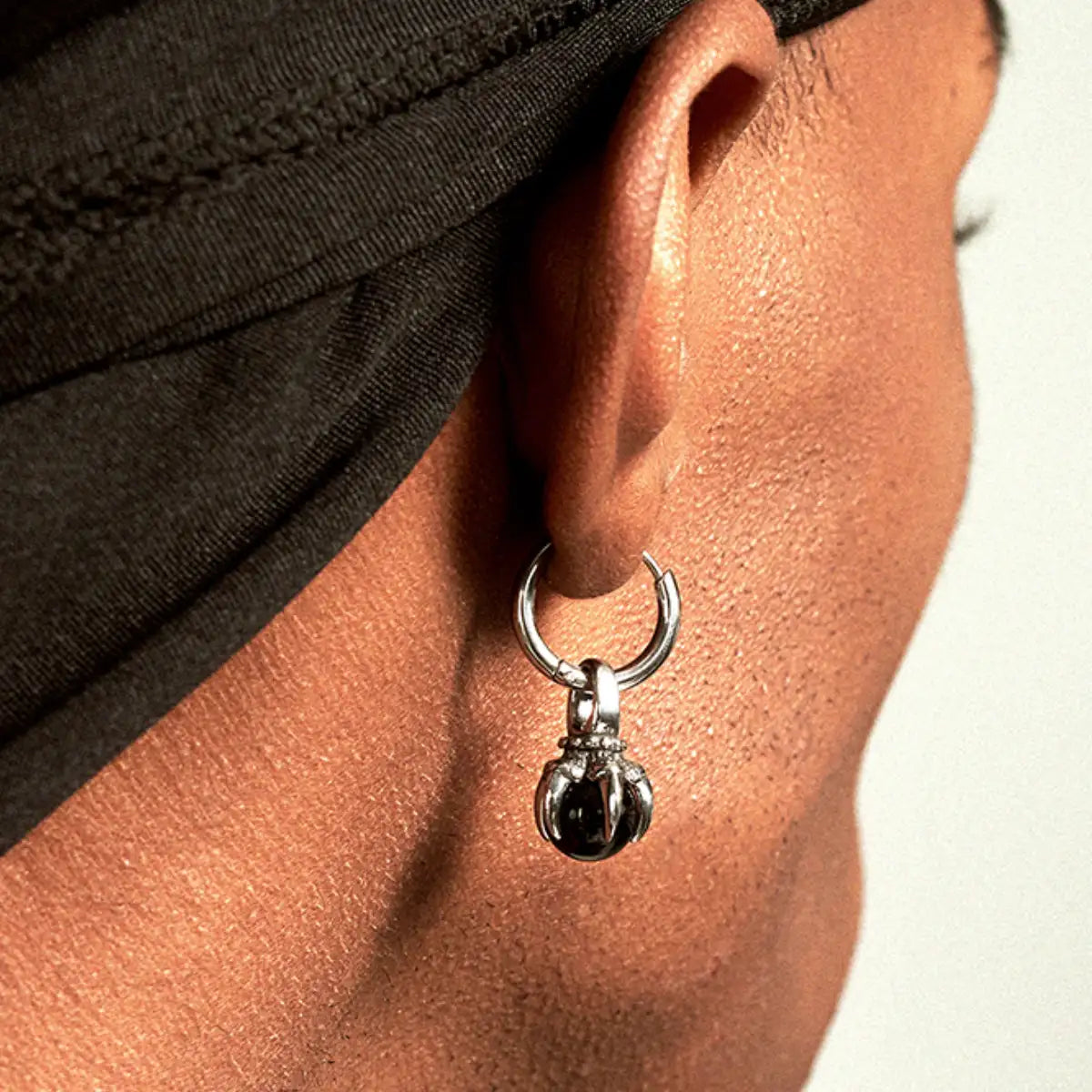 Black Onyx Dangle Earrings with Claw Setting Worn by Male Model Back View