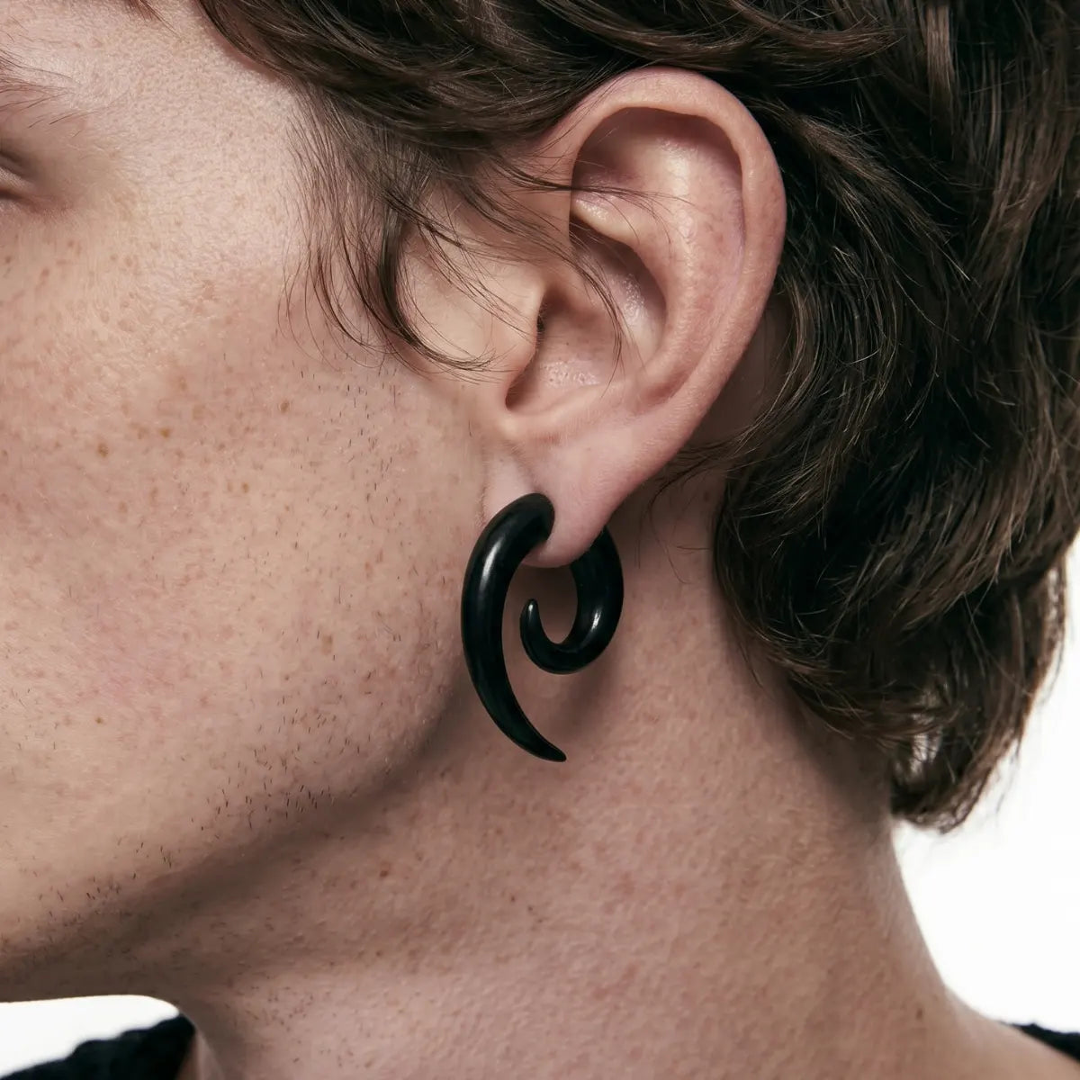 Black Spiral Horn Earrings Worn by Male Model Close Up Side View
