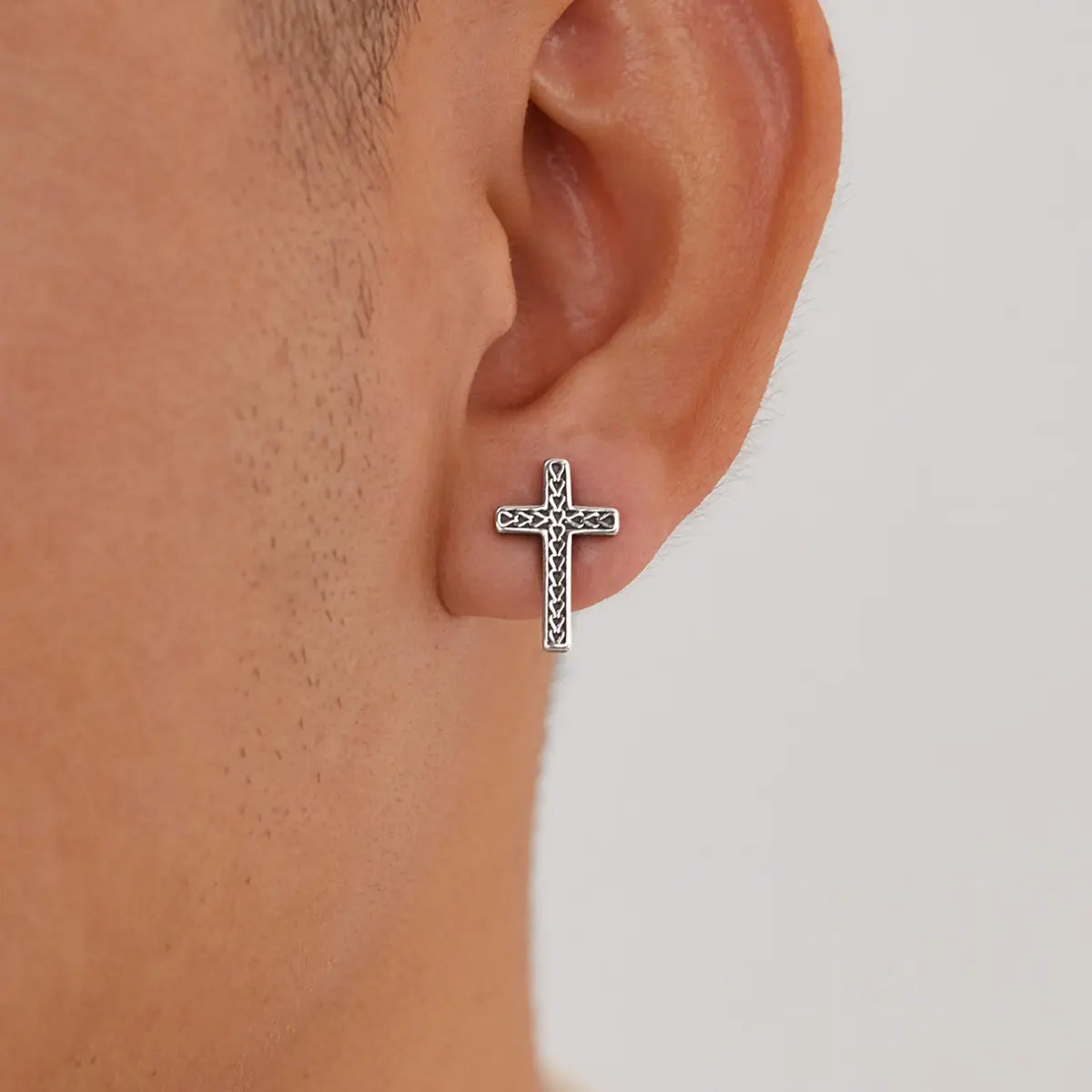 Braided Cross Stud Earrings Worn by Male Model Close Up