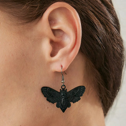 Butterfly Skull Dangle Earrings Black Worn by Female Model