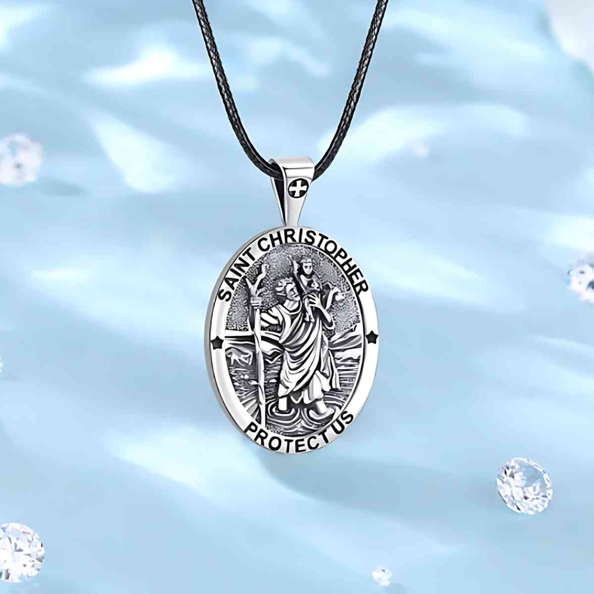 Detailed Silver St Christopher Necklace with Prayer Displayed on Blue Surface Xenos Jewelry