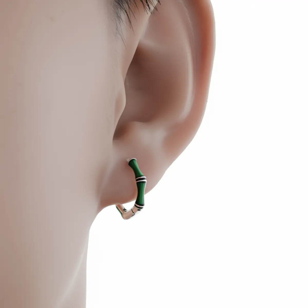 Emerald bamboo silver hoop earrings worn by male model