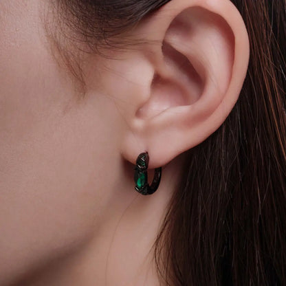 Eye of Horus Hoop Earrings Emerald CZ Worn by Female Model Close up