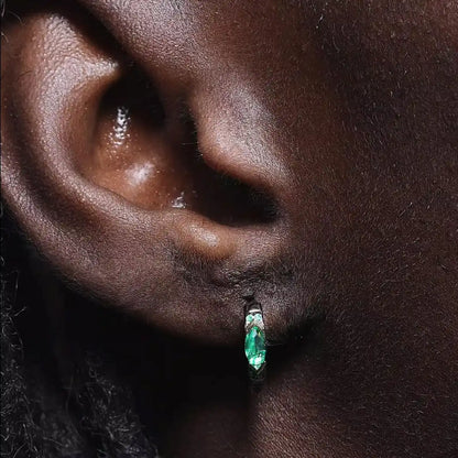 Eye of Horus Hoop Earrings Emerald CZ Worn by Male Model Close up