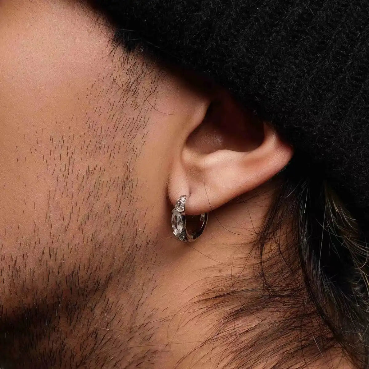 Eye of Horus Hoop Earrings White CZ Worn by Male Model Close up