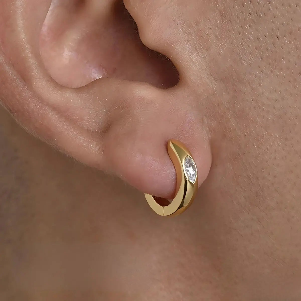 Eye of Horus Huggie Hoop Earrings Gold 4mm Worn by Male Model Close Up