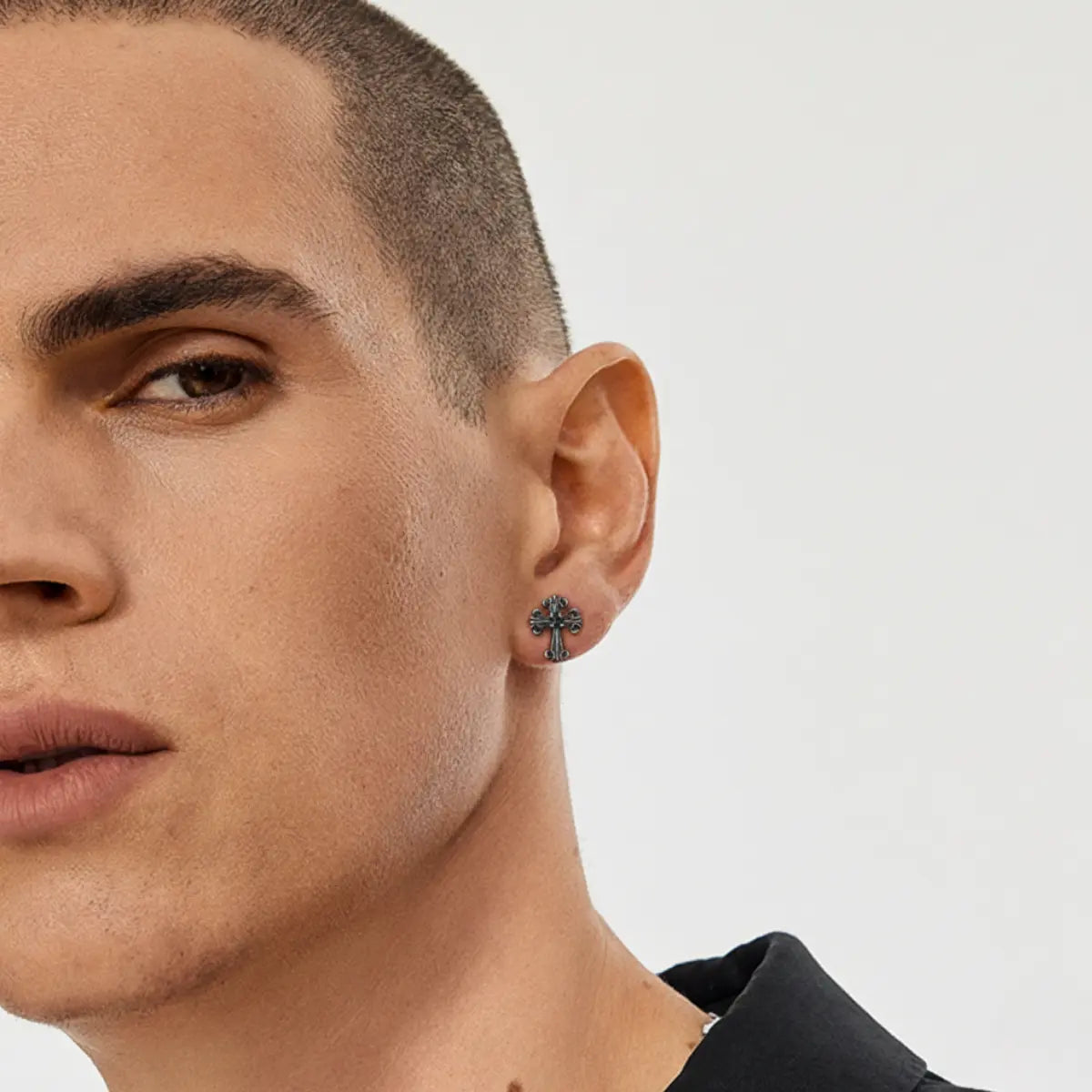 Fleur de Lis Cross Stud Earrings Worn by Male Model Side