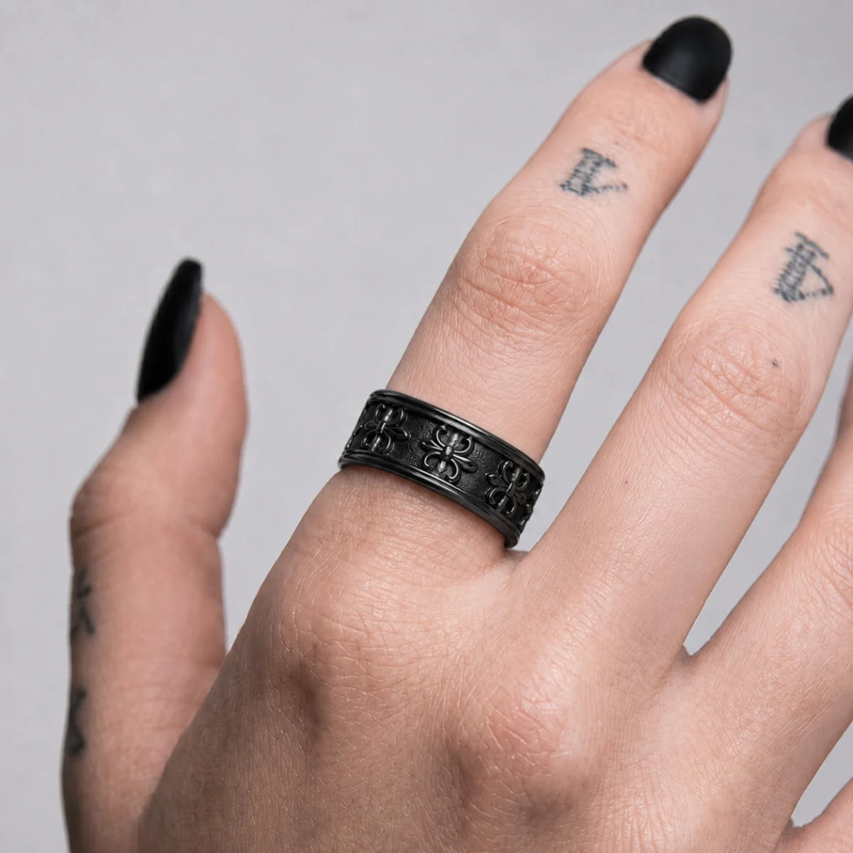 Fleur de Lis Spinner Ring Black Worn on Hand Close Up
