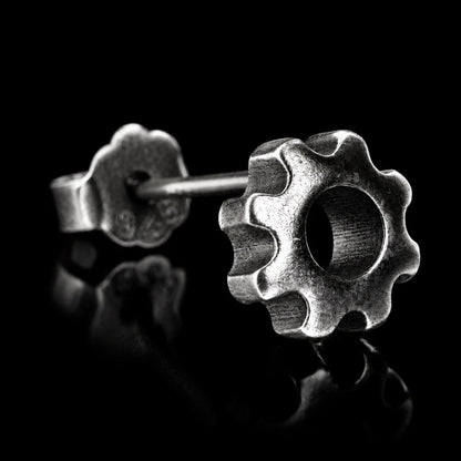 Gear Stud Earrings Single Earring Close Up Black Background