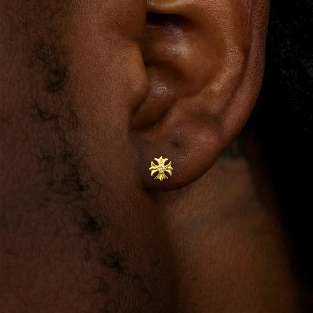 Gold Petal Cross Stud Earrings Worn by Male Model Side