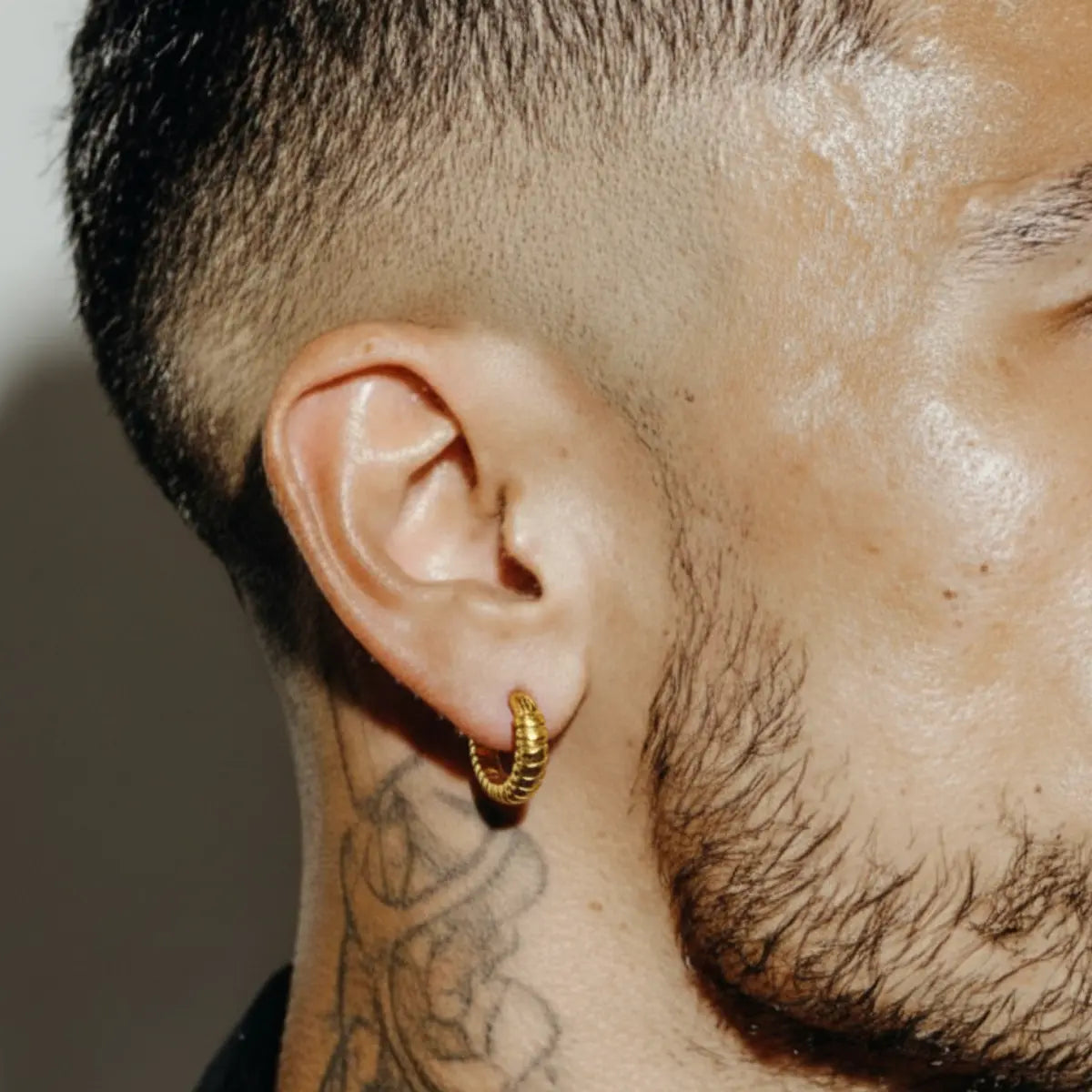 Gold Snake Skin Hoop Earrings Worn by Male Model