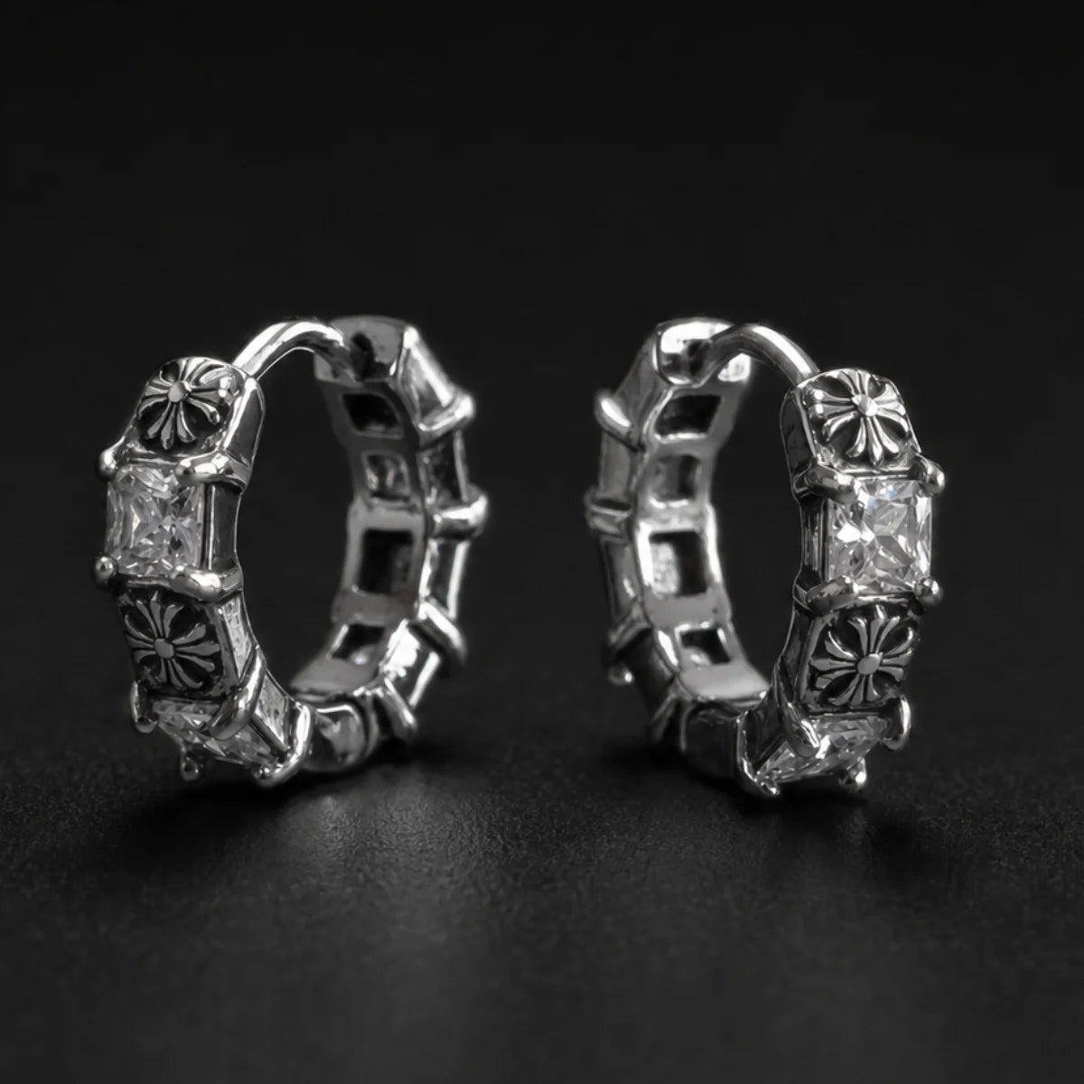 Gothic Cross CZ Huggie Hoop Earrings Silver Pair Close Up Black Background