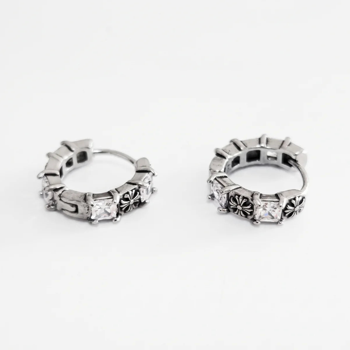 Gothic Cross CZ Huggie Hoop Earrings Silver Pair Flat Lay White Background