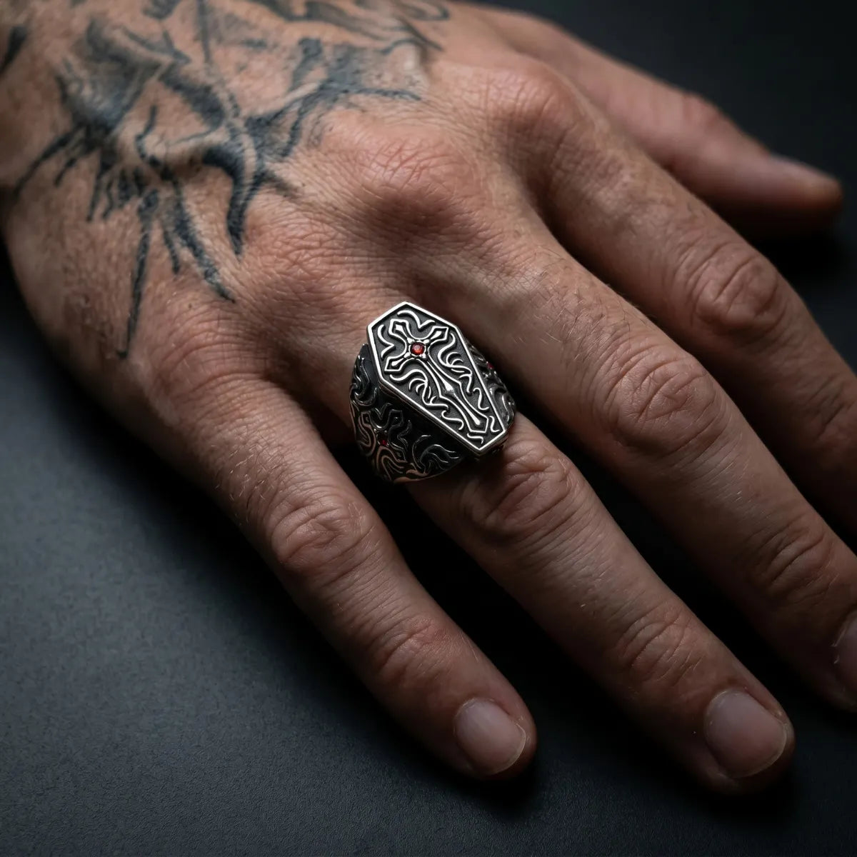 Gothic Cross Coffin Ring with Red Gemstone Worn by Male Model