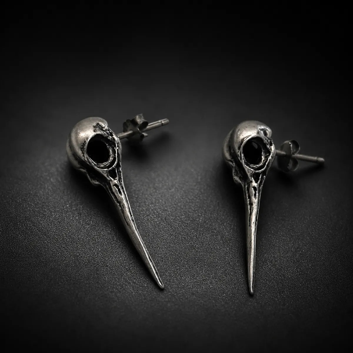 Hummingbird Skull Earrings Silver Pair Displayed Black Background