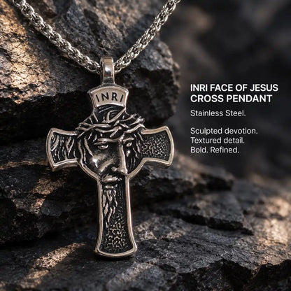 INRI Face of Jesus Cross Pendant Antique Silver Displayed on Stone Surface