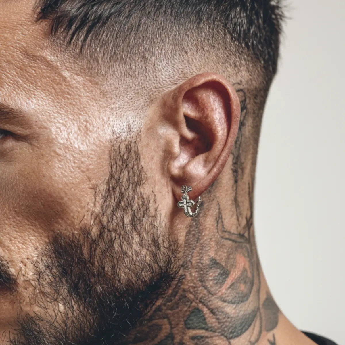 Iced Out Cross Huggie Hoop Earrings Worn by Male Model