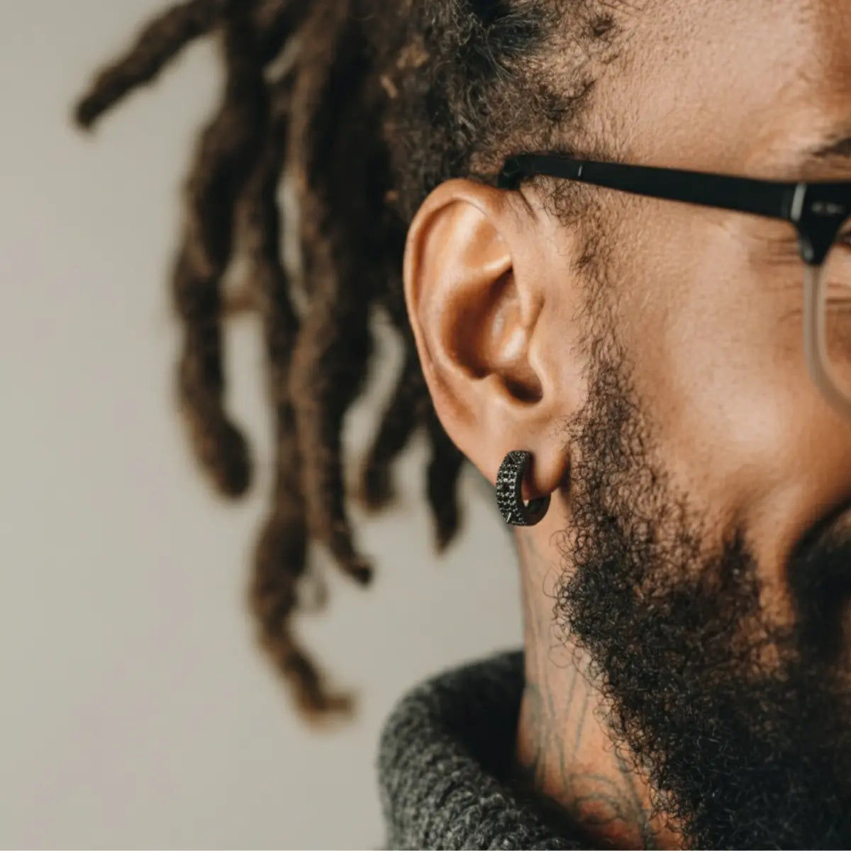 Iced Out Spikelet Hoop Earrings Black Worn by Male Model Front