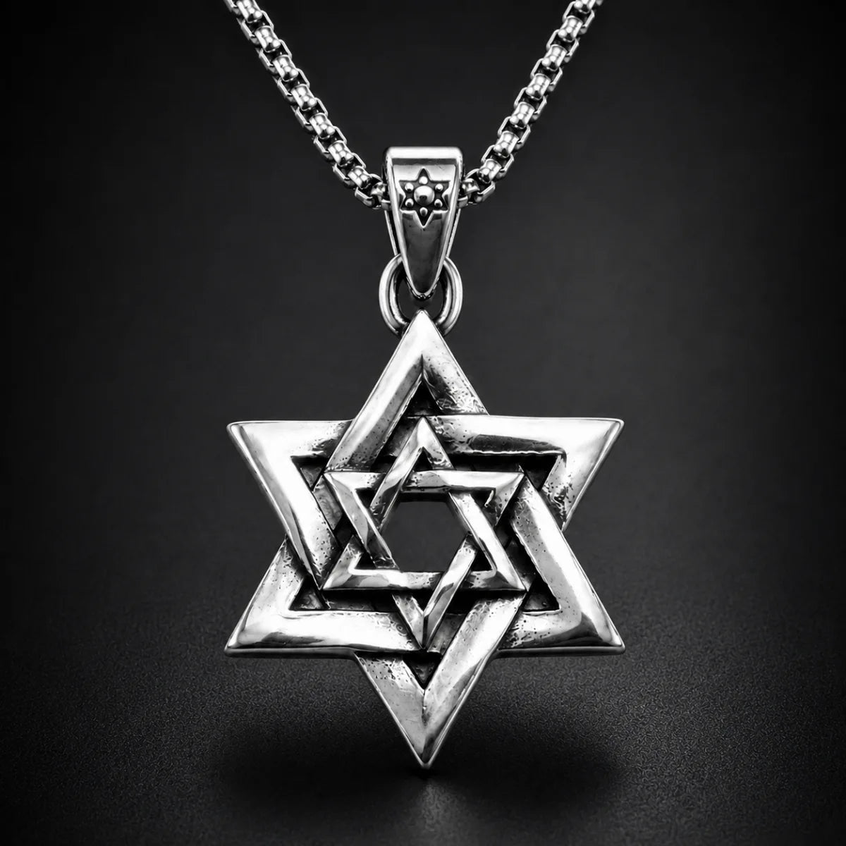 Interlocking Star of David Necklace Silver Close Up Black Background