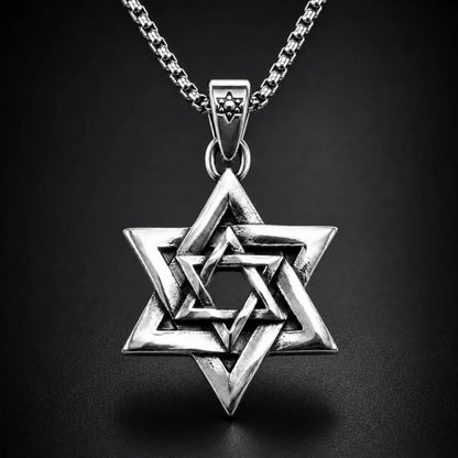 Interlocking Star of David Necklace Silver Close Up Black Background