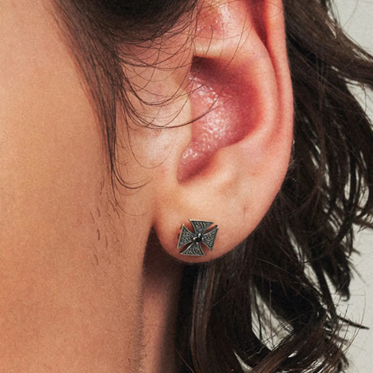 Iron Cross Stud Earrings with Black Gem Worn by Male Model Close Up Side
