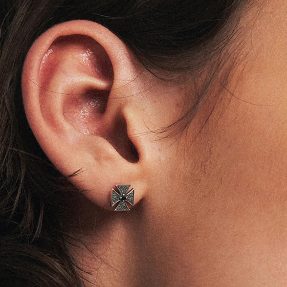 Iron Cross Stud Earrings with Black Gem Worn by Male Model Close Up  