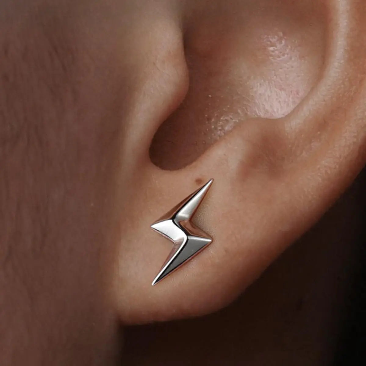 Lightning bolt stud earrings 925 silver worn by male model close up