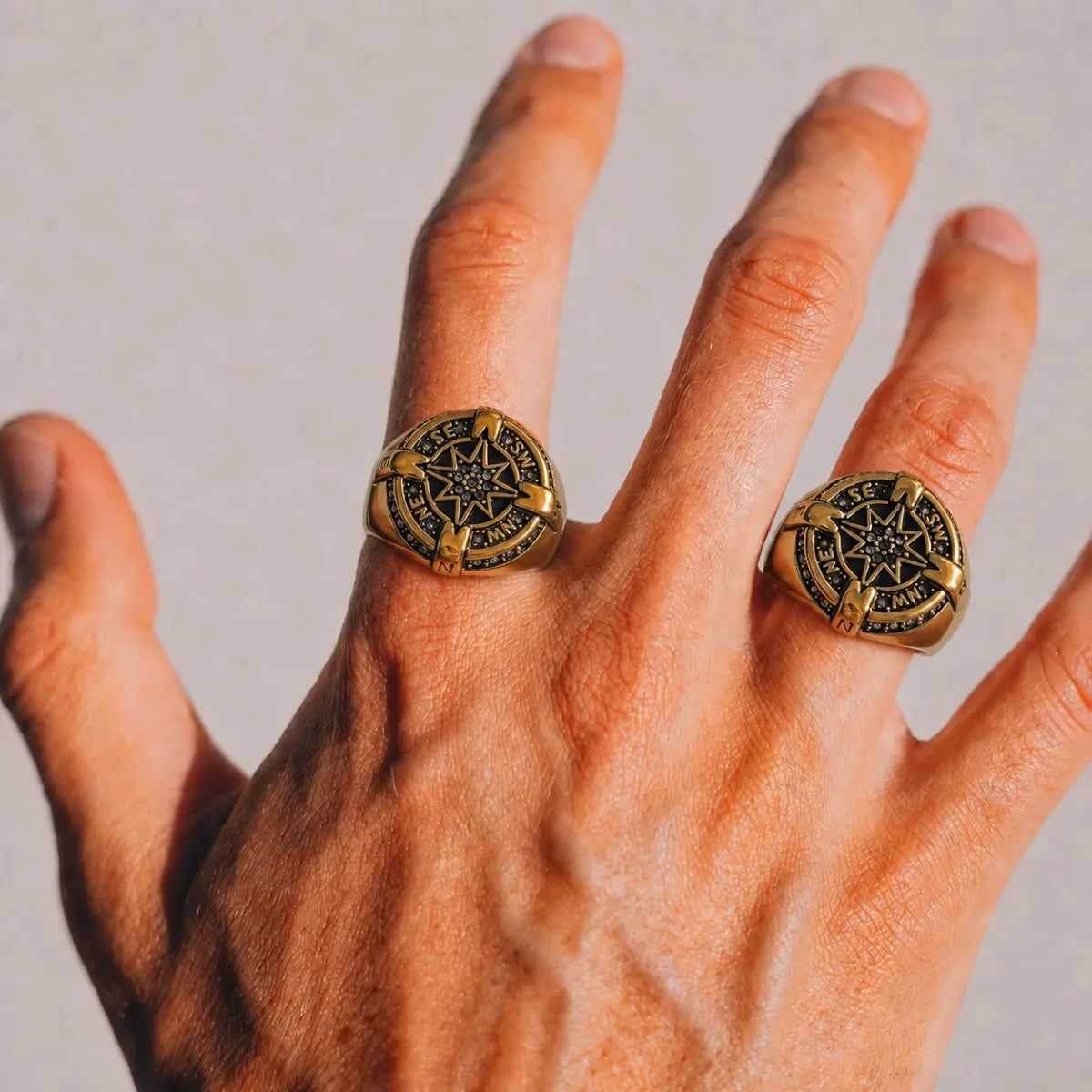 Luxury Compass Ring Gold Worn on Male Hand Close Up