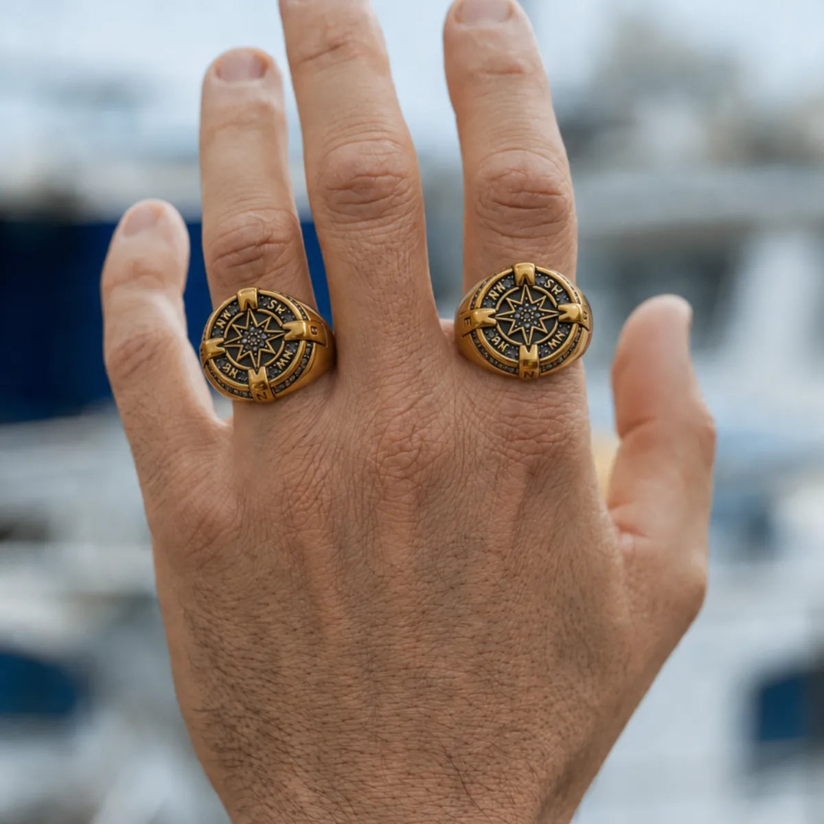 Luxury Compass Ring Gold Worn on Male Hand Outdoor Background