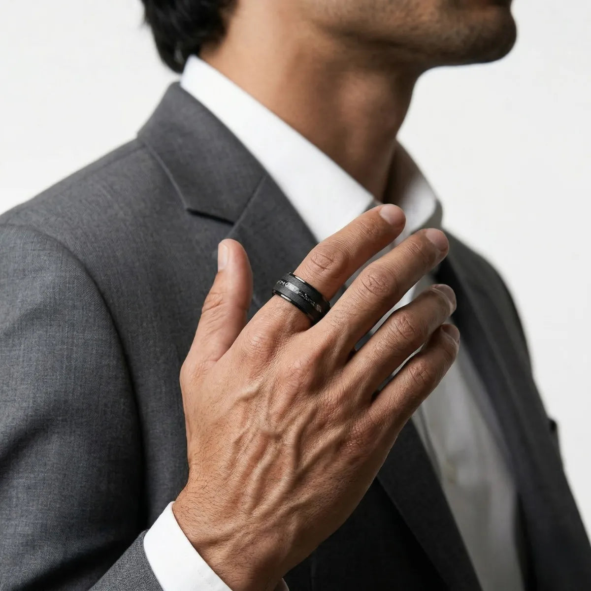 Medium shot of male model in casual clothing wearing the Black Meteorite Tungsten Ring