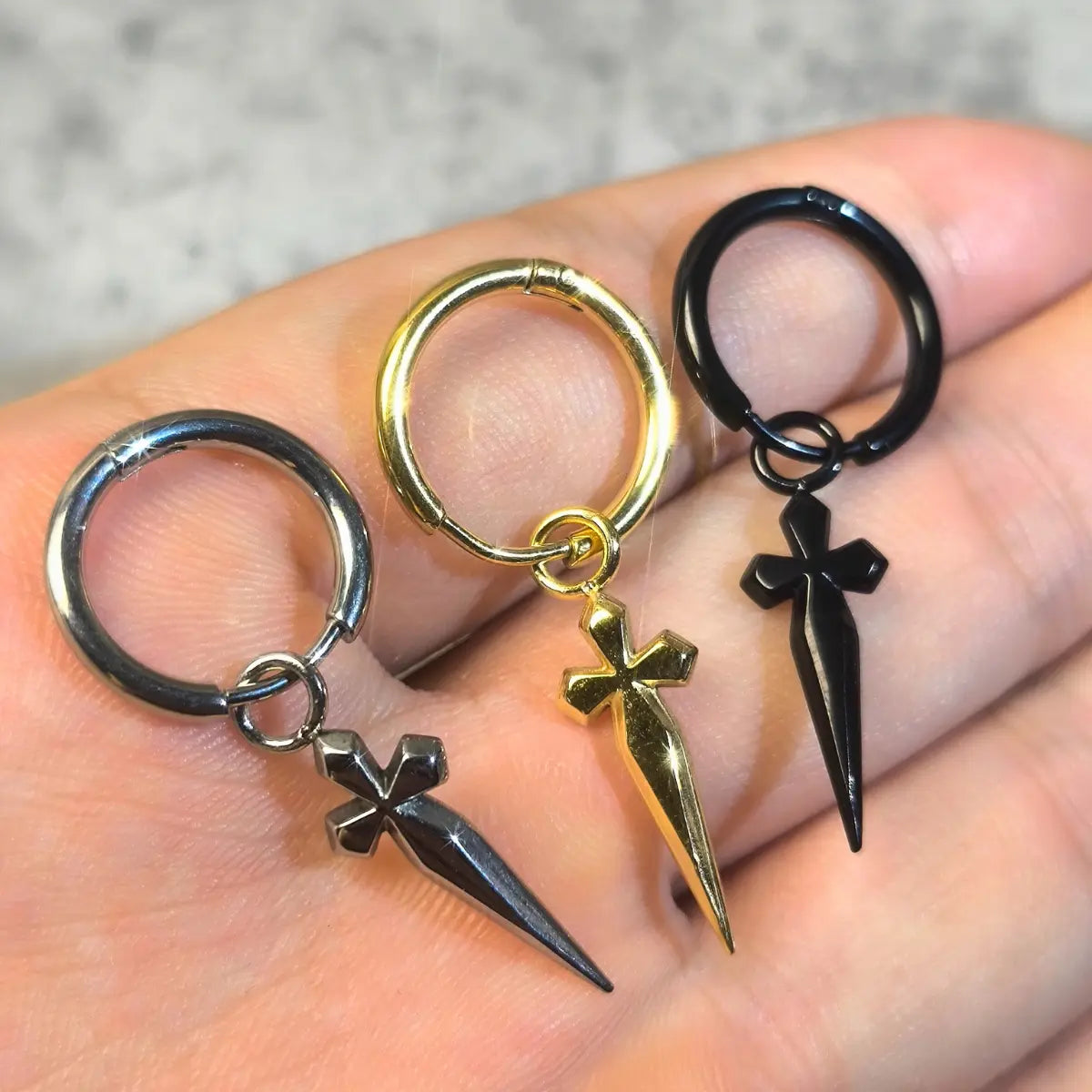 Men's Dagger Earrings Presented in Hand - Xenos Jewelry