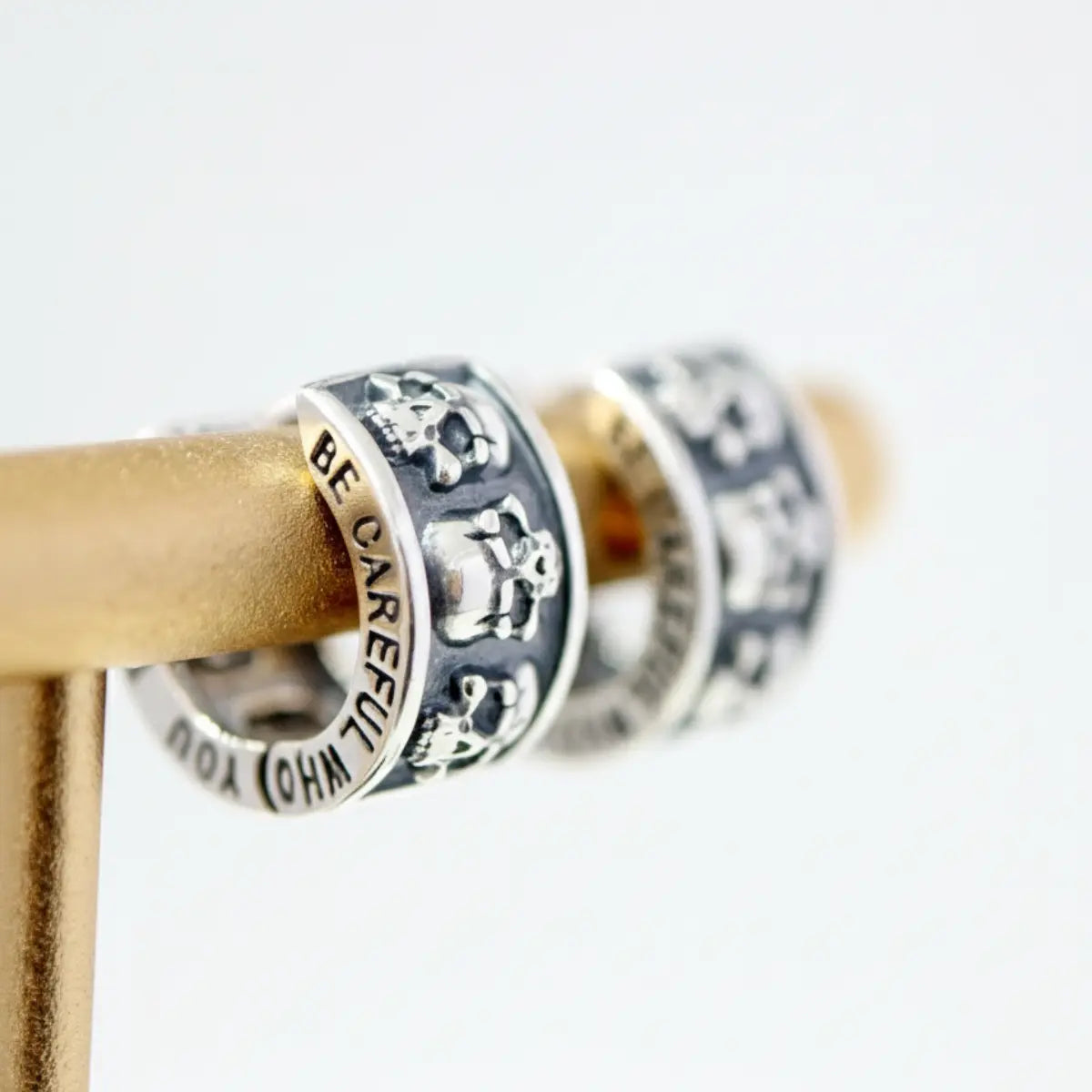 Men's Silver Skull Huggie Hoop Earrings Close Up