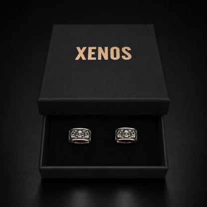 Men's Silver Skull Huggie Hoop Earrings Displayed in Xenos Jewelry Box