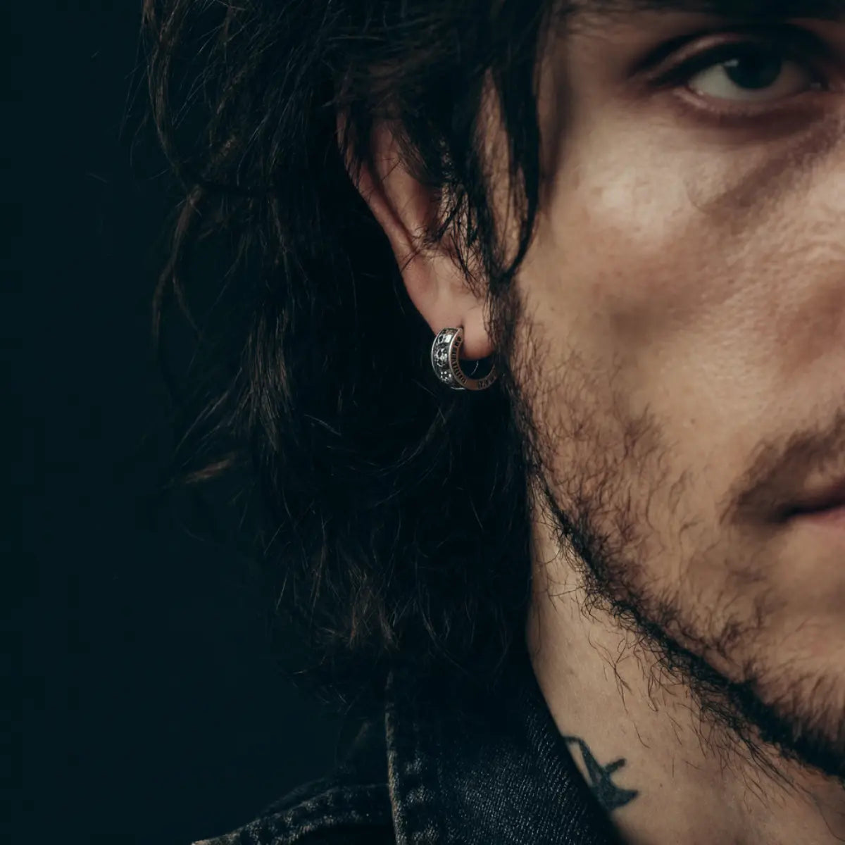 Men's Silver Skull Huggie Hoop Earrings Worn by Male Model Close Up