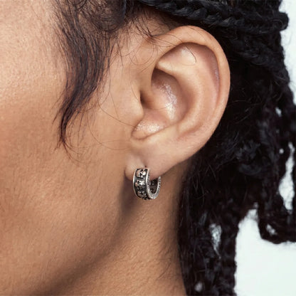 Men‘s Silver Skull Huggie Hoop Earrings Worn by Male Model Side View