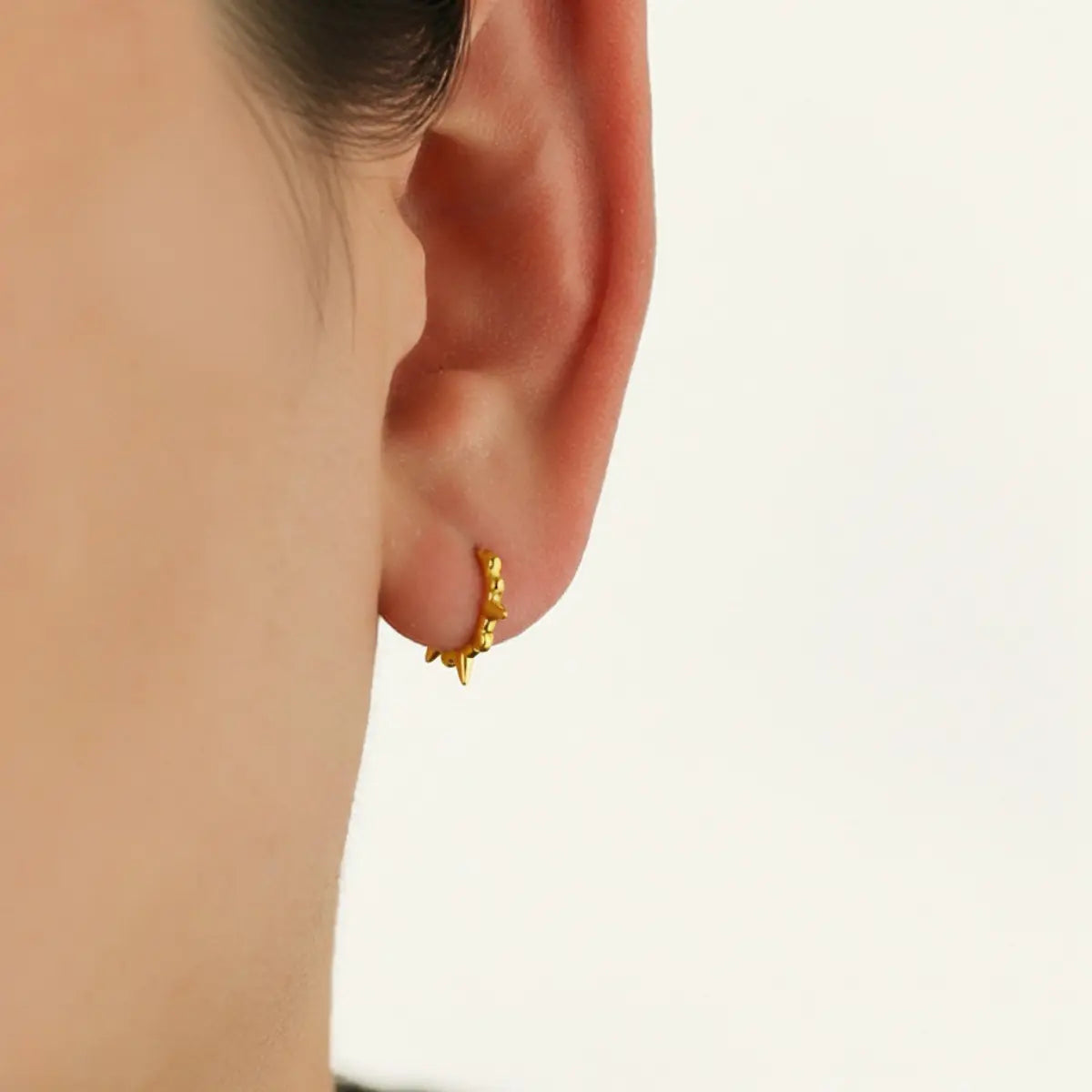 Mini Spike Huggie Hoop Earrings Gold Worn by Female Model