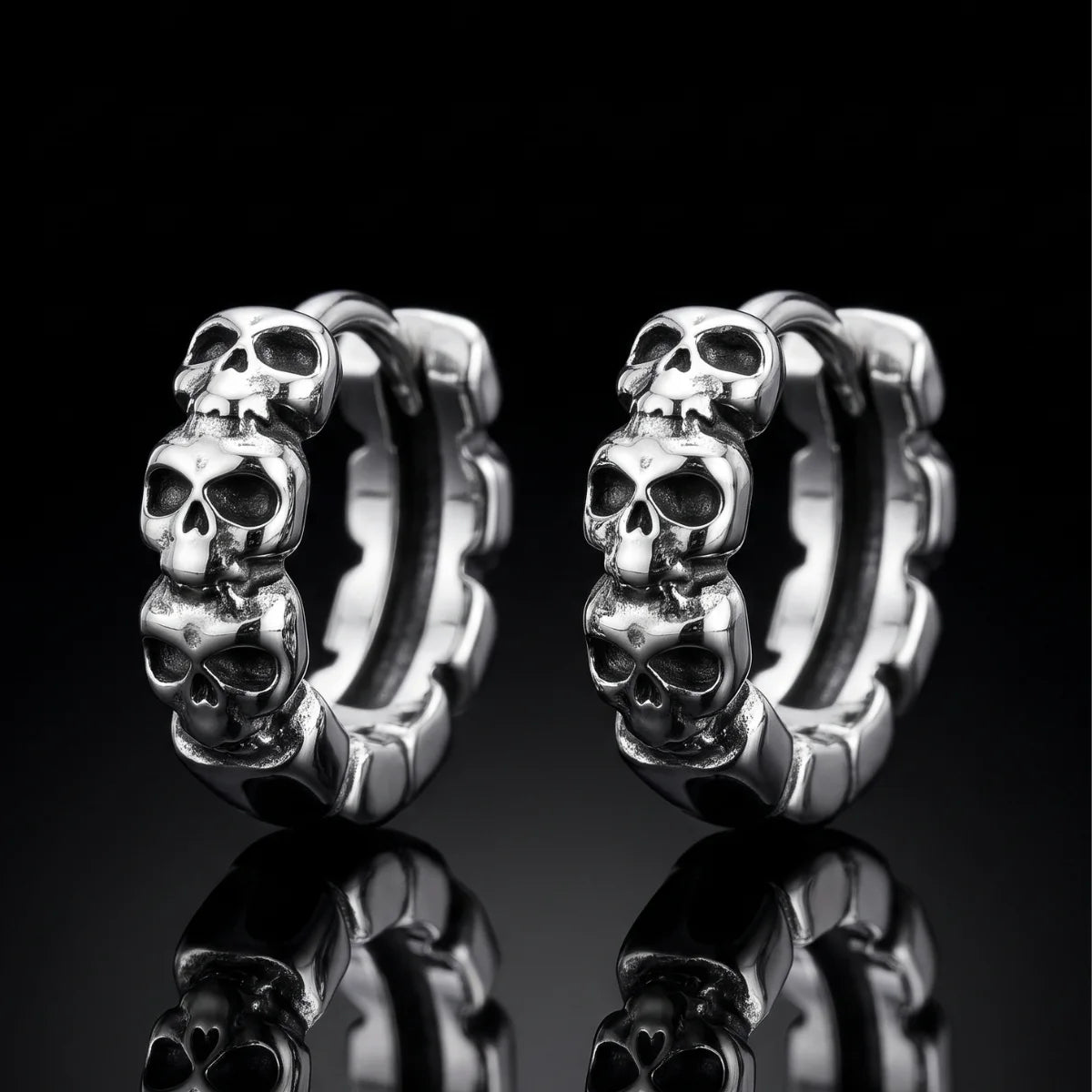Multi Skull Head Huggie Earrings Silver Pair Close Up Black Background