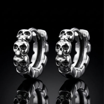 Multi Skull Head Huggie Earrings Silver Pair Close Up Black Background
