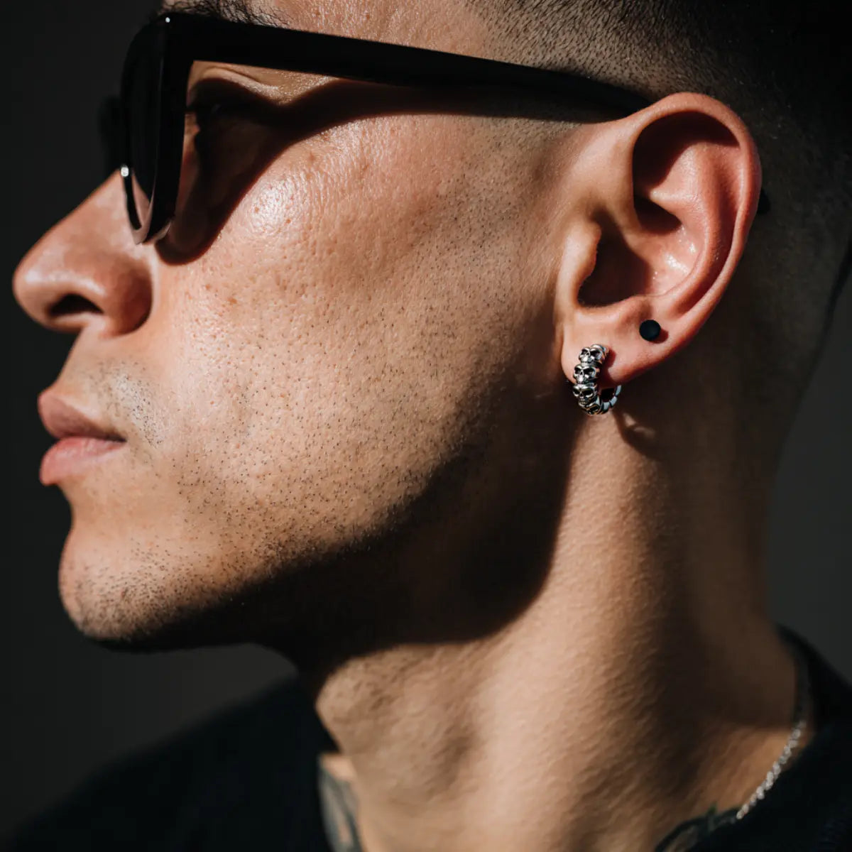 Multi Skull Huggie Hoop Earrings Worn by Male Model Side