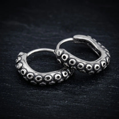 Octopus Tentacle Hoop Earrings Close Up on Dark Slate Background
