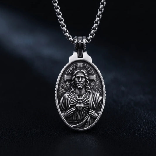 Oval Jesus Cross Pendant with Sacred Heart Silver Close Up Black Background
